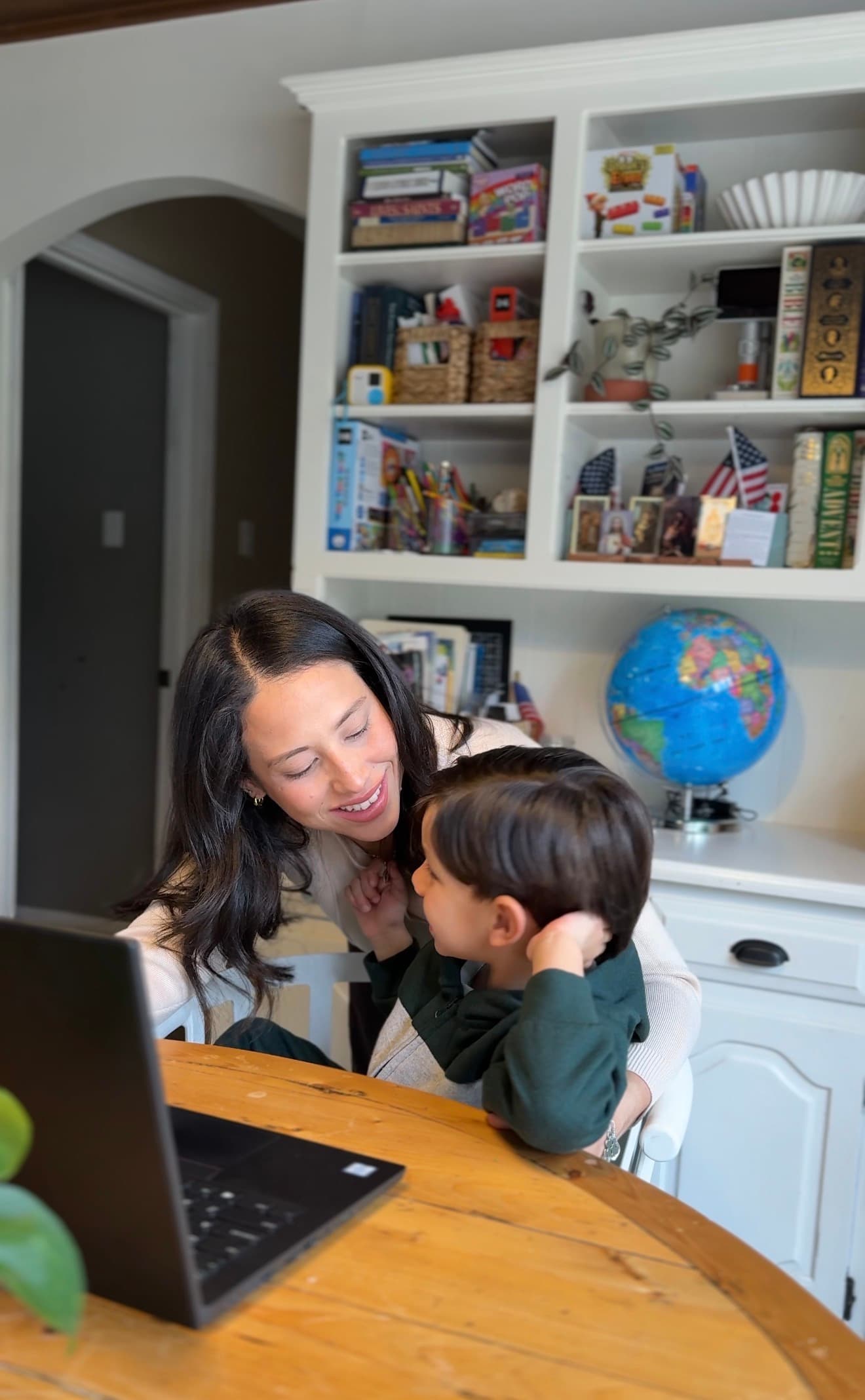 Daniela with her son at their homeschool desk