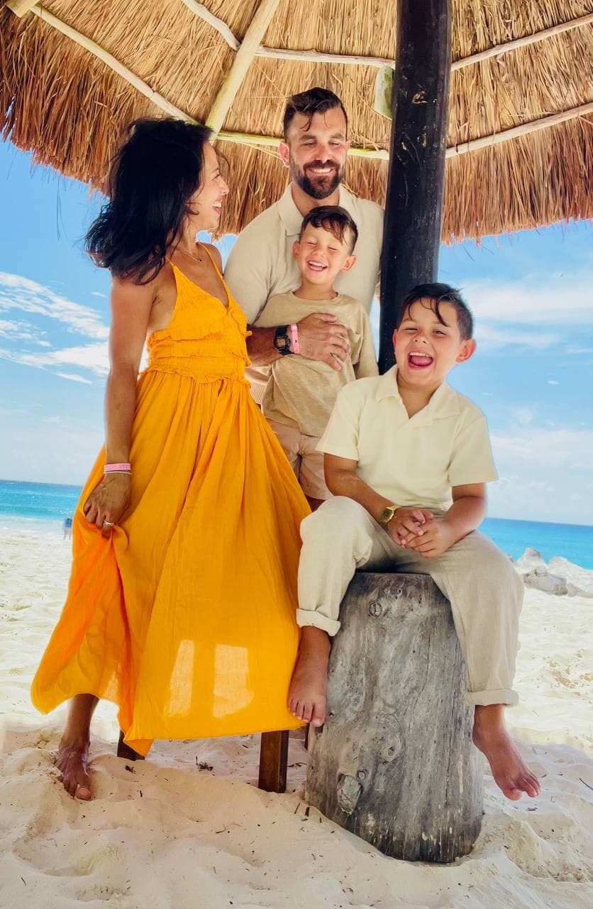 Daniela with her family under a beach palapa