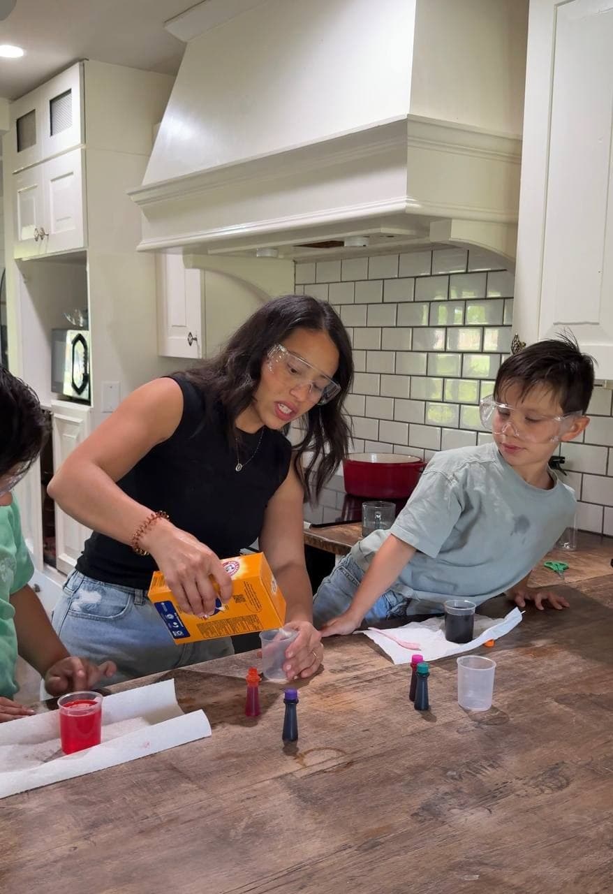 Daniela guiding a kitchen science activity with her children