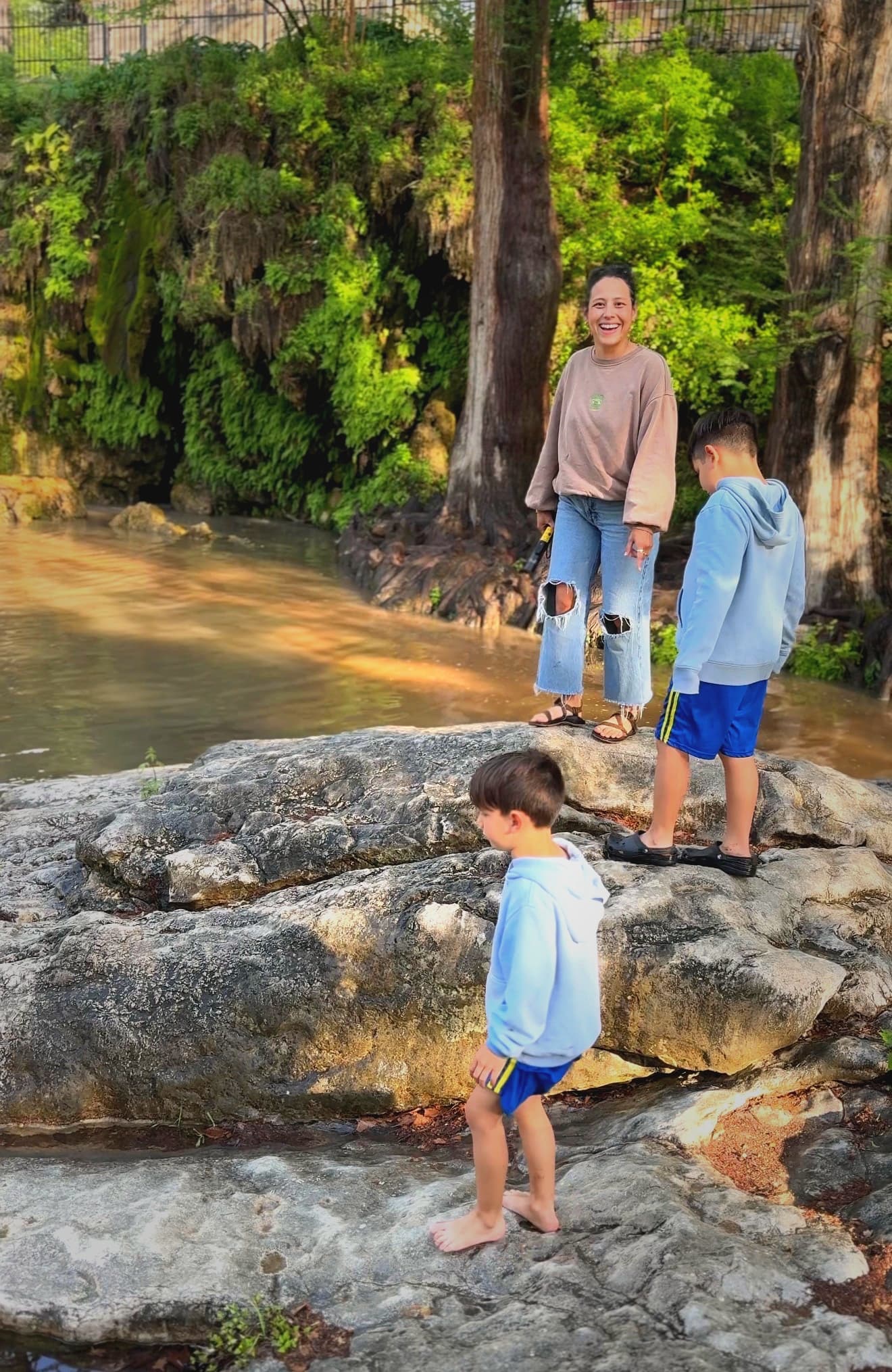 Daniela and her boys at a creek